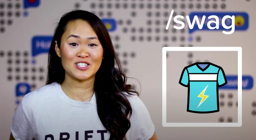 A video still of a woman presenting beside a “/swag” graphic with a T-shirt icon.